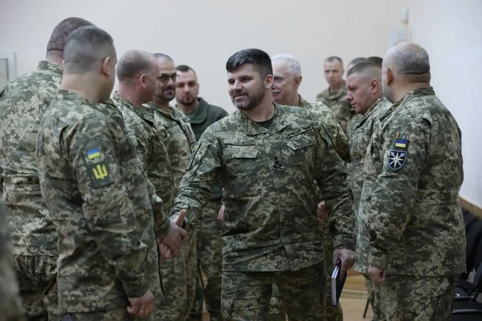 A group of soldiers in the military corps discusses tactics