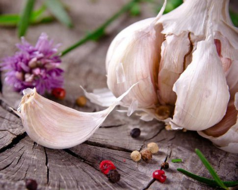 Garlic on a plate next to vegetables