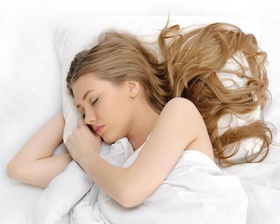 girl with loose hair in bed