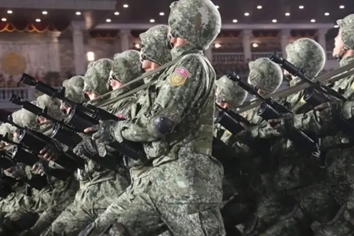 Military in the uniform of the National Army of North Korea on a tank