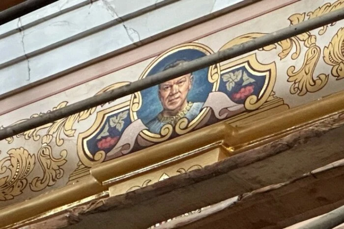 Portraits of businessmen on the walls of the temple