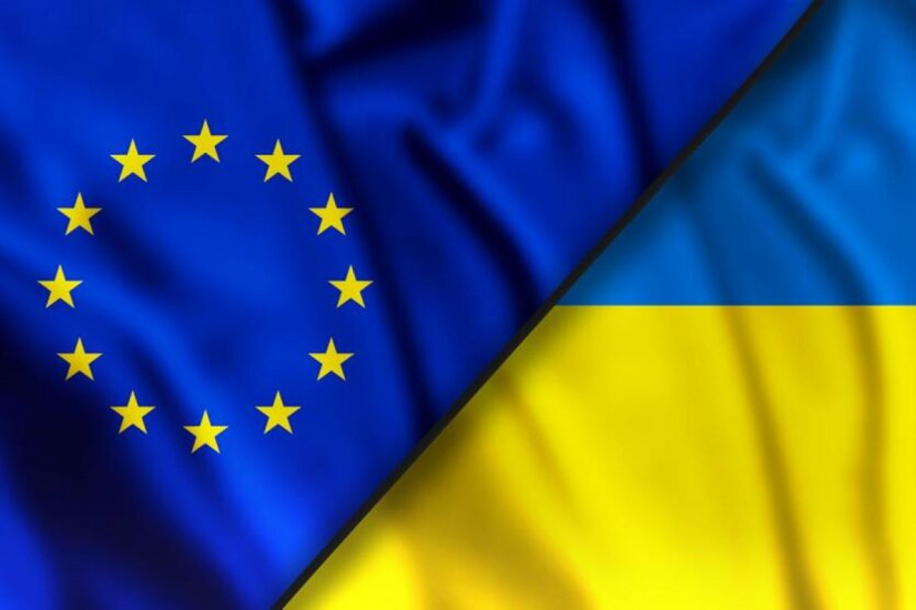 Flags of Ukraine and EU under the clouds