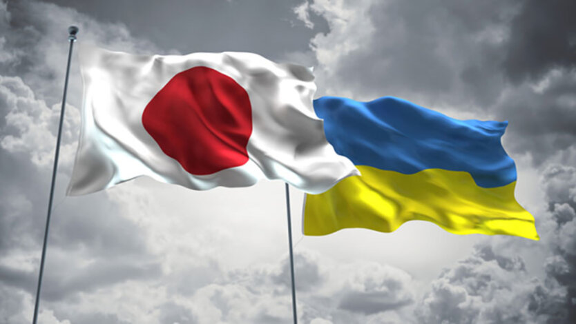 Logo of Ukraine and Japan in hands