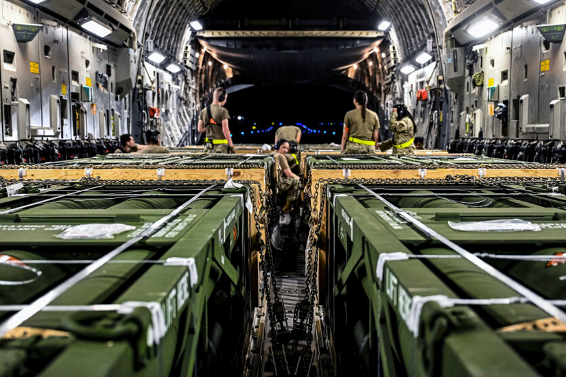 Helicopters and tanks against a bright background