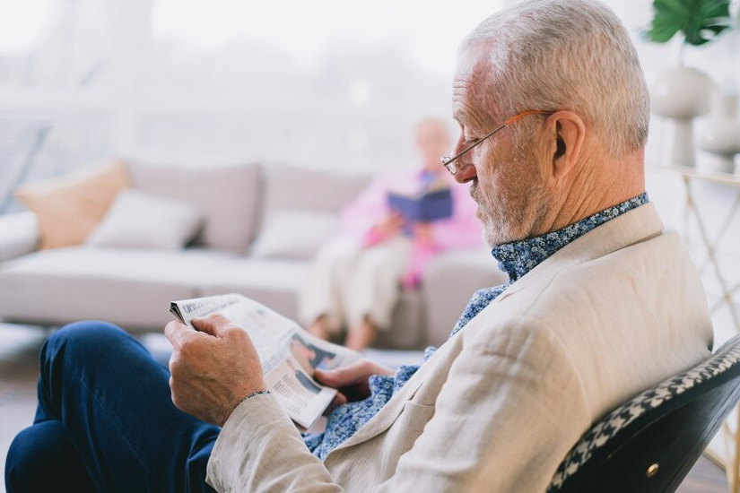 Elderly pensioner with hryvnias in hands