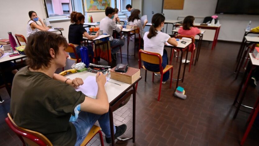 A teacher with closed eyes is ripping a gas tape